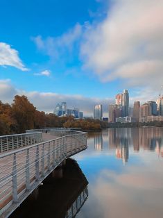 a bridge that is over some water with buildings in the background