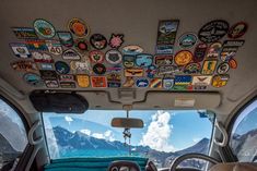 the inside of a vehicle with many stickers on it's ceiling and dashboard