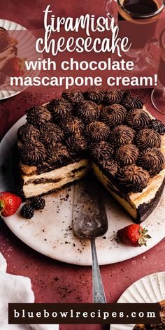 a cake with chocolate frosting and strawberries on the top is sitting on a plate