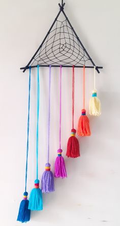 the colorful tassels are hanging on the wall