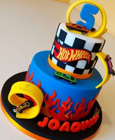 a birthday cake with hot wheels on top