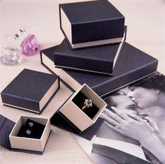 a couple's wedding rings are in their boxes