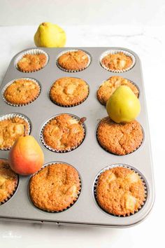 muffins with apples and an apple on top in a pan, ready to be baked