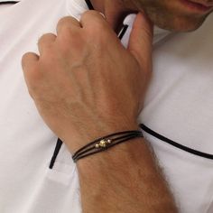 Designer leather bracelet for him. Meticulously fashioned from premium leather cords, this captivating creation showcases an exquisite blend of gold or silver accents.  A refined expression of masculinity. Its understated yet unique design effortlessly complements any attire. The bracelet boasts an adjustable size, thanks to the incorporation of a chain segment.  Tailoring the fit is a breeze - simply select a chain link and secure it with the reliable lobster clasp. A splendid gift choice for a boyfriend or husband, perfect for birthdays, anniversaries, and other special occasions! Features: - Multi-layered bracelet - Adjustable - Top quality guaranteed - Gift for him - Nice wrapping - Worldwide shipping Details: Genuine Leather 14K Gold Filled or 925 Sterling Silver beads Size: It adjust Black Leather Bracelet Men, Bracelet Boyfriend, Mens Bracelet Personalized, Gold Bead Bracelet, Leather Bracelet For Men, Leather Cord Bracelets, Mens Gold Jewelry, Black Leather Bracelet, Men Bracelet