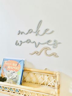 a basket with books on top of it and a sign that says make waves above it