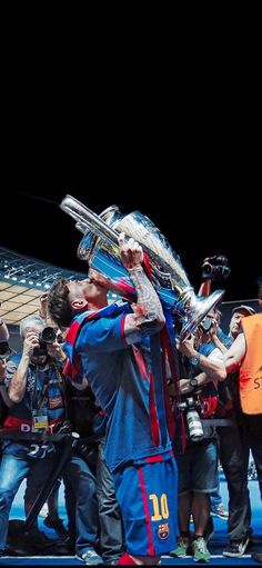 the soccer players are hugging each other while holding their trophies in front of them and posing for pictures