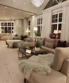 a living room filled with furniture and a chandelier