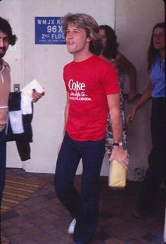 two men in red shirts and blue pants