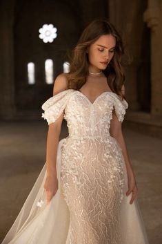 a woman in a white wedding dress is posing for the camera with her hand on her hip