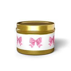 a pink bow on white and gold tin canister with ribbon around the top,