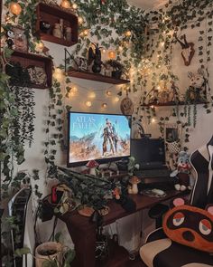 a desk with a computer on top of it and lots of plants growing up the wall