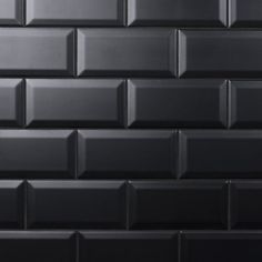 a black tile wall that is very close to the ground