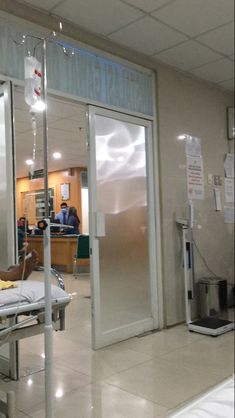 a hospital room filled with medical equipment and people