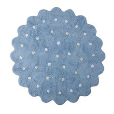 a blue rug with white polka dots on the top and bottom, it has a circular shape