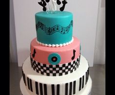 a three tiered cake with musical notes on it