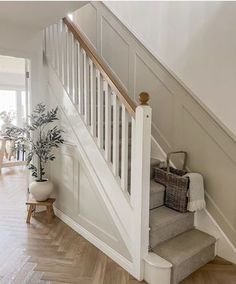 the stairs in this house have been painted white and are lined with wood flooring