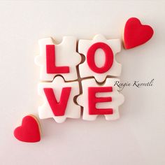 the word love spelled with red and white cookies