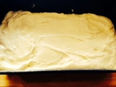 a cake that is sitting on top of a pan with frosting and icing