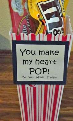 a popcorn box filled with snacks on top of a wooden table