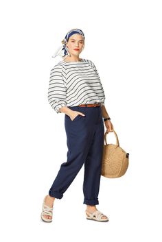 a woman in striped shirt and blue pants holding a basket