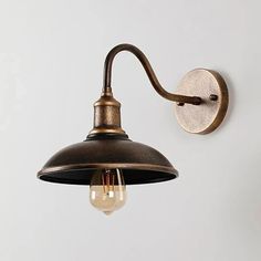 an old - fashioned wall light is hanging on the wall, with a single bulb