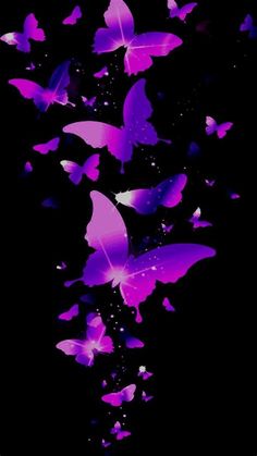 a group of purple butterflies flying in the air with their wings spread out and glowing