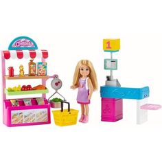 a doll is standing in front of a play kitchen