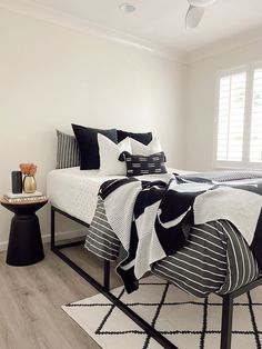 a bedroom with white walls and black accents