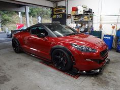 a red sports car parked in a garage