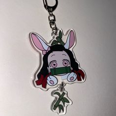 a keychain with an image of a bunny wearing a bandana on it