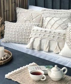 a couch with pillows and coffee cups on it