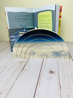 an open book sitting on top of a wooden table