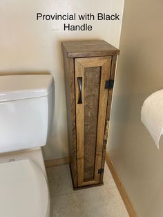 a wooden cabinet next to a white toilet in a bathroom with the words provincial with black handle