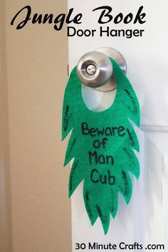 a door hanger with the words beware of man club written on it, hanging from a door handle