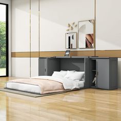 a bed sitting on top of a hard wood floor next to a wall mounted mirror