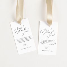 two tags with the words thank you written on them are hanging from a gold ribbon