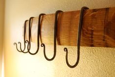 five hooks are hanging on the wall next to each other