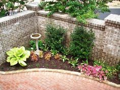 an outdoor garden with brick walls and landscaping