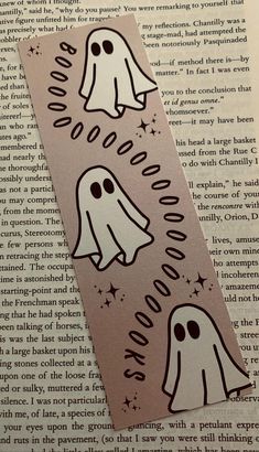 some stickers that are on top of an open book with the words ghost written in it