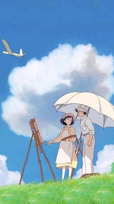 two people standing under an umbrella in front of a painting easel on top of a hill