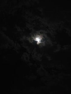 the moon is shining brightly in the dark sky