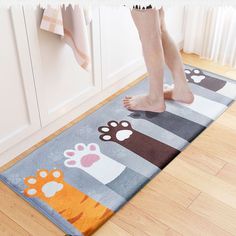 a person standing on top of a bathroom rug