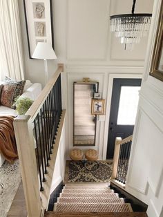 the stairs in this house are made of wood and wrought iron, with decorative rugs on them