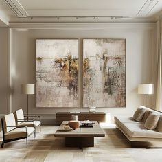 a living room with two paintings on the wall and couches in front of it