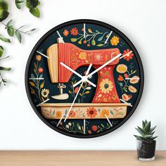 a wall clock with a sewing machine painted on it's face and flowers in the background