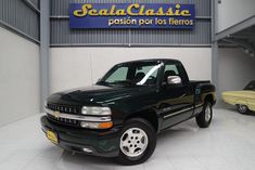 a black pick up truck parked in a garage