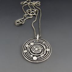 "Solar System Necklace - Sterling Silver, Planet Necklace, Universe Necklace, Space Charm, Adventure Jewelry, Cosmos, Graduation Gift, Astronomer \"And, when you want something, ALL the Universe conspires in helping you achieve it.\" The Alchemist Follow your dreams, love your truth. Do what brings joy to your heart and soul...for it knows the way. This silver planetary charm is hand crafted from eco friendly recycled sterling silver. It hangs from your choice of sterling silver oxidized chains. Planet Necklace For Men, Sterling Silver Space-themed Jewelry, Silver Planet Necklace, Planets Necklace, Adventure Jewelry, Space-themed Silver Round Pendant Necklace, Universe Necklace, Astronomy Necklace, Solar System Jewelry