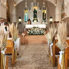 two rows of pews with flowers and grass in front of the alter at a church