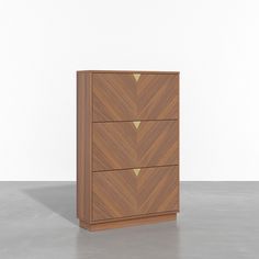 a wooden dresser with three drawers on one side and two gold triangles on the other