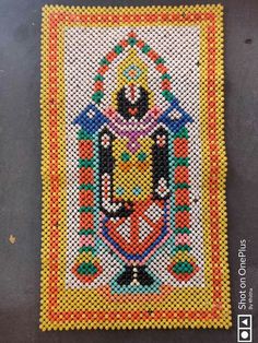 a cross stitched rug with an image of a person in the center on it